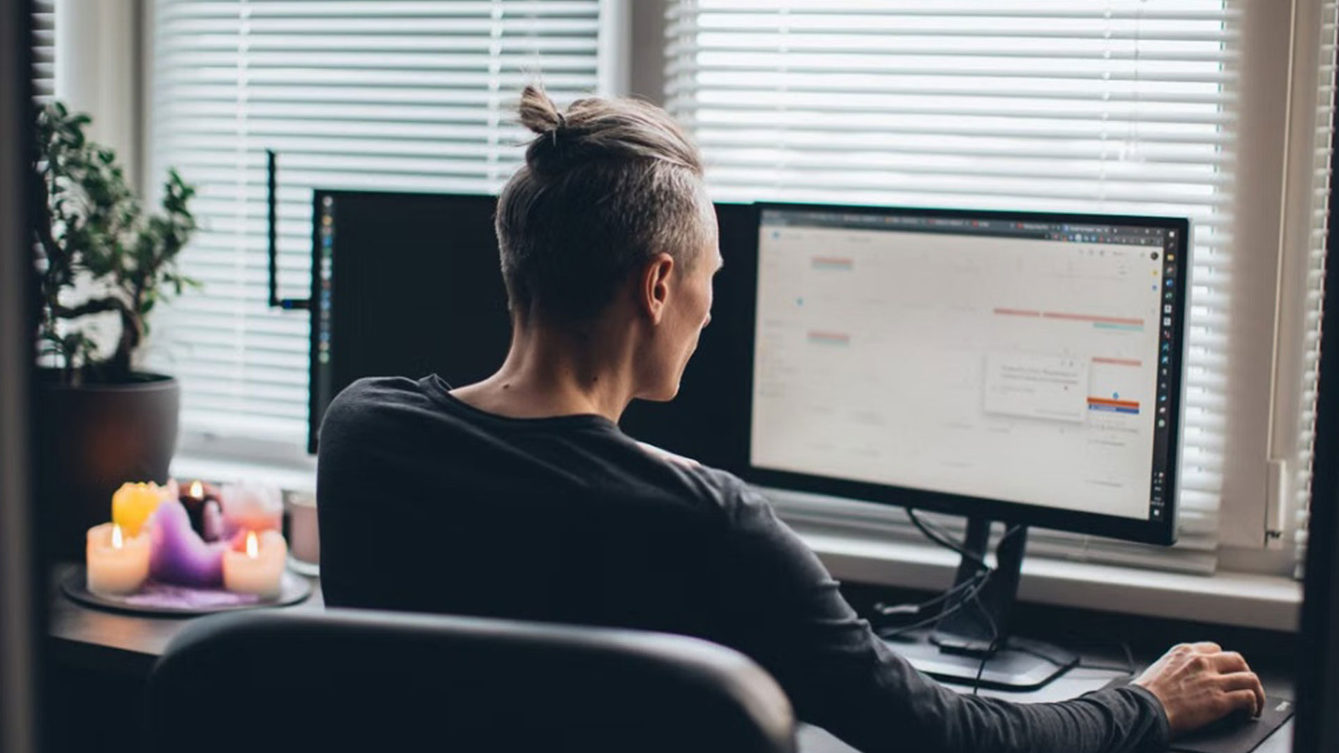 A freelancer comparing time tracking and invoicing apps side by side on a laptop screen